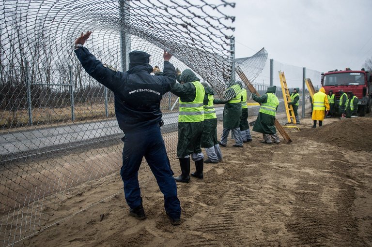 Building a fence on the border with Serbia in southern Hungary this month. Credit Sandor Ujvari/European Pressphoto Agency